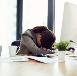 Woman with head down on desk
