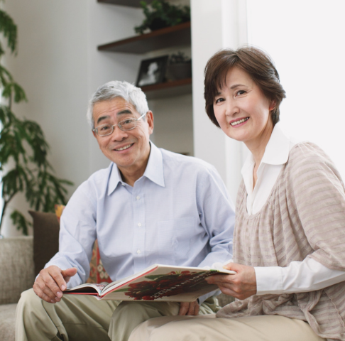 Elderly man and woman sitting together reading